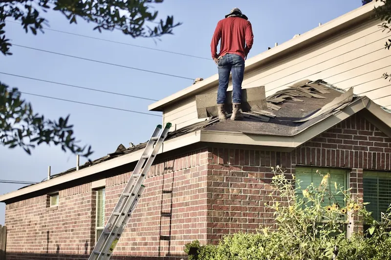 Professional roofer working on a residential roof in California Heights